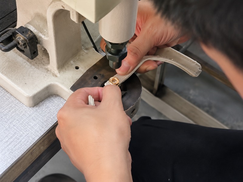 inserting-hardware-into-a-bag-belt-using-a-Grommet-Machine