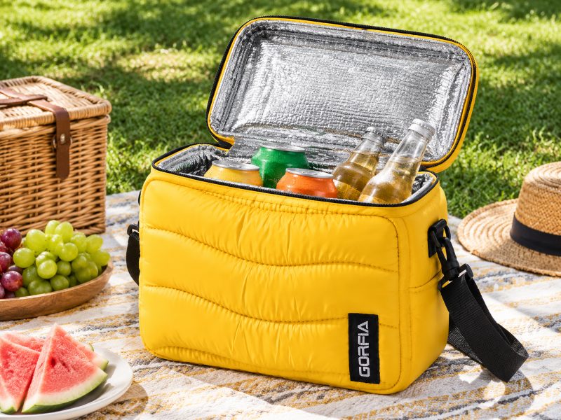 Yellow-portable-insulated-cooler-bag-open-on-picnic-blanket-outdoor-camping-cooler-tote