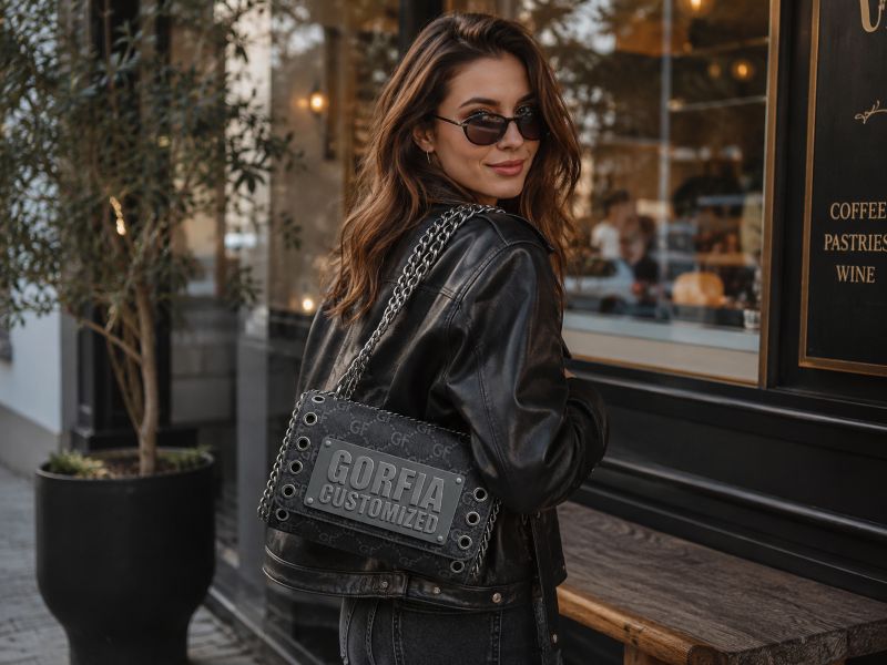 a-woman-carrying-black-denim-chain-bag