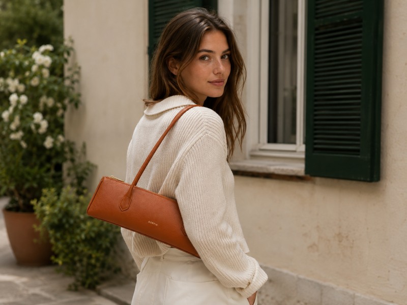 a-woman-carrying-saddle-brown-long-bag