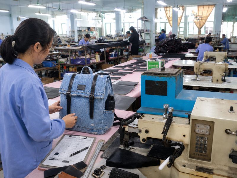 a-worker-is-checking-the-backpack-by-checking-the-details-carefully