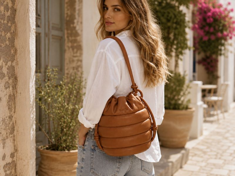 woman-with-brown-puffer-bucket-bag