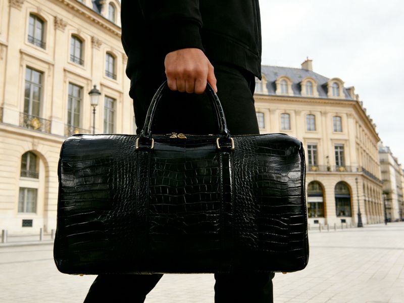 person-holding-black-luggage-bag-for-short-trips-and-weekend-getaways-in-city