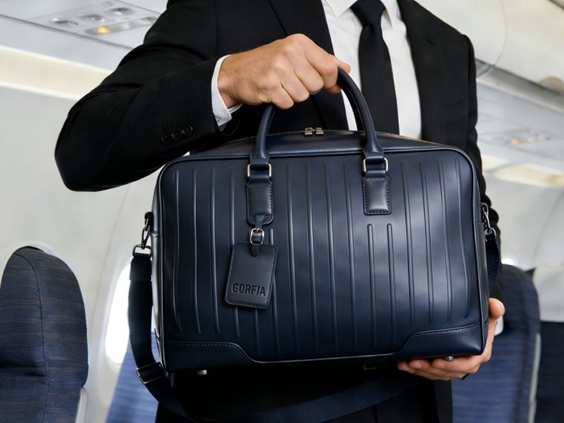businessman-holding-soft-sided-luggage-travel-bag-for-short-trips-on-airplane